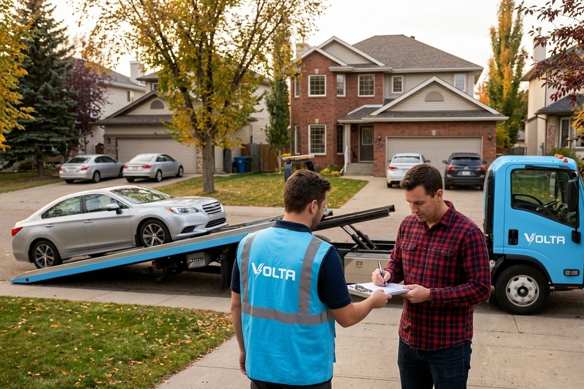 A Volta team member with a customer beside a Volta tow truck